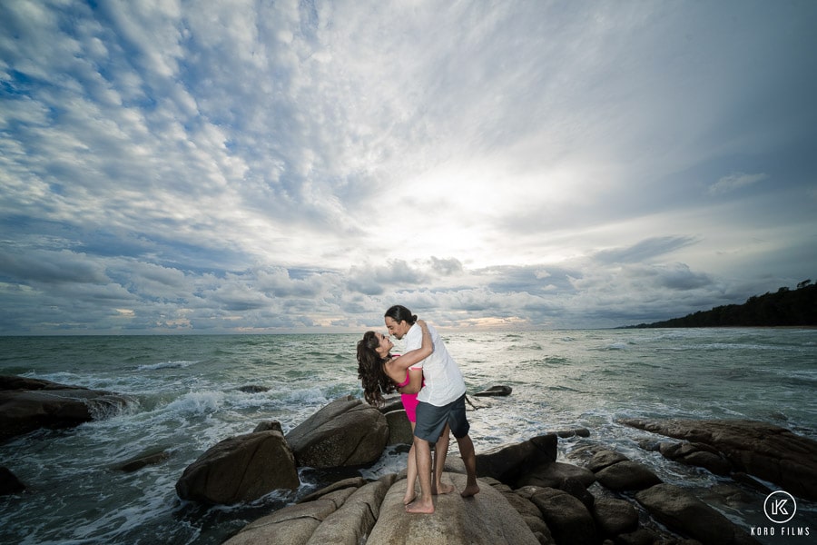 Prewedding panorama sea on the rocks sky couple embrace