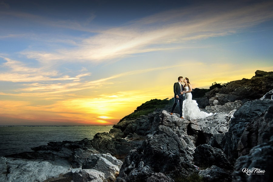 Prewedding on the rocks wedding dress by sea at sunset