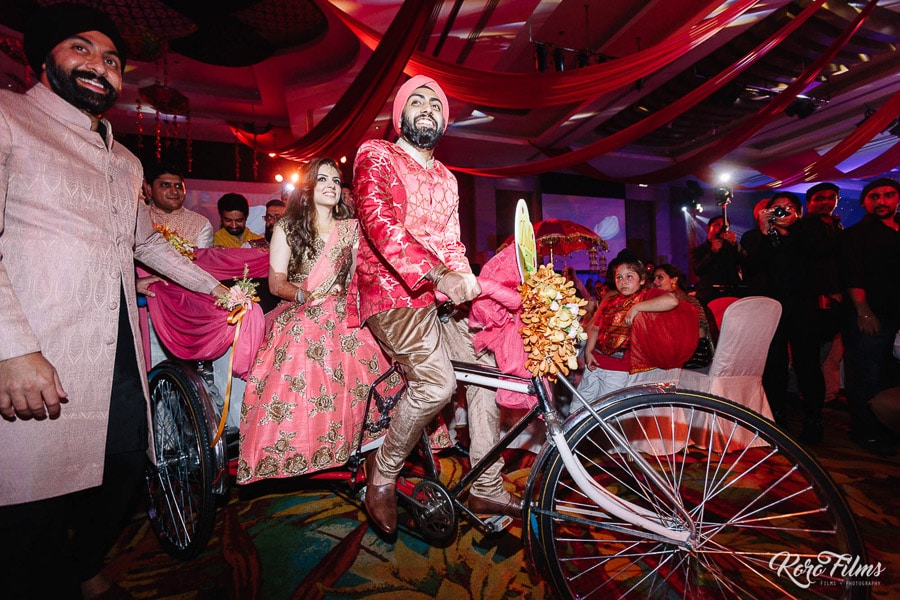 Indian wedding Sangeet Cycling in bride and groom