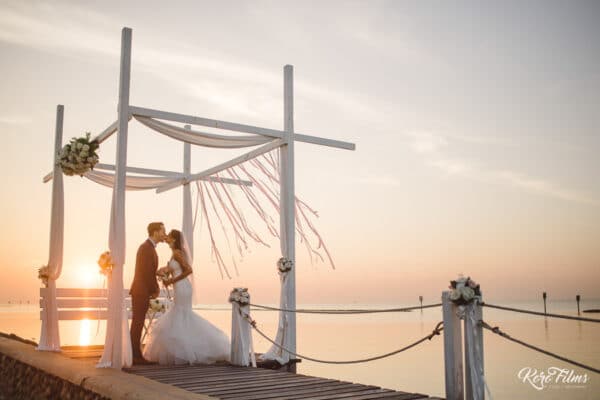 Western Wedding kiss in the setting sun at Bang Pu Recreation Centre