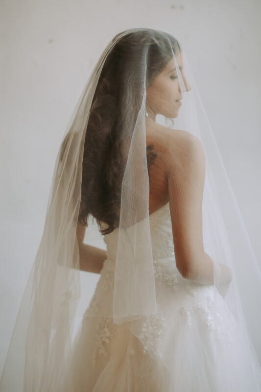 Bride and groom on vintage sofa, editorial pre wedding photography at Benedict Studio Bangkok
